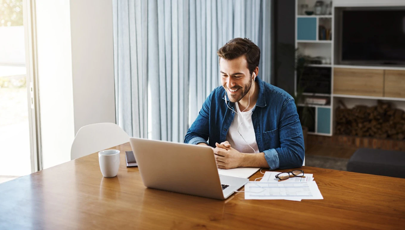 man at desk by laptop