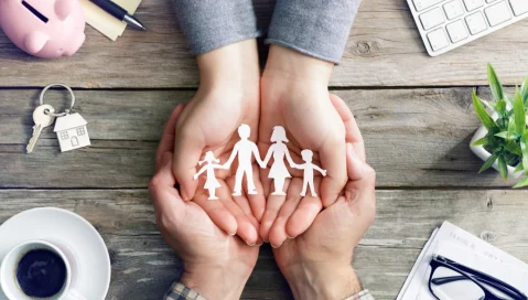 Hands holding family cutout
