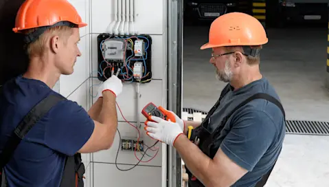 Men checking electrical box