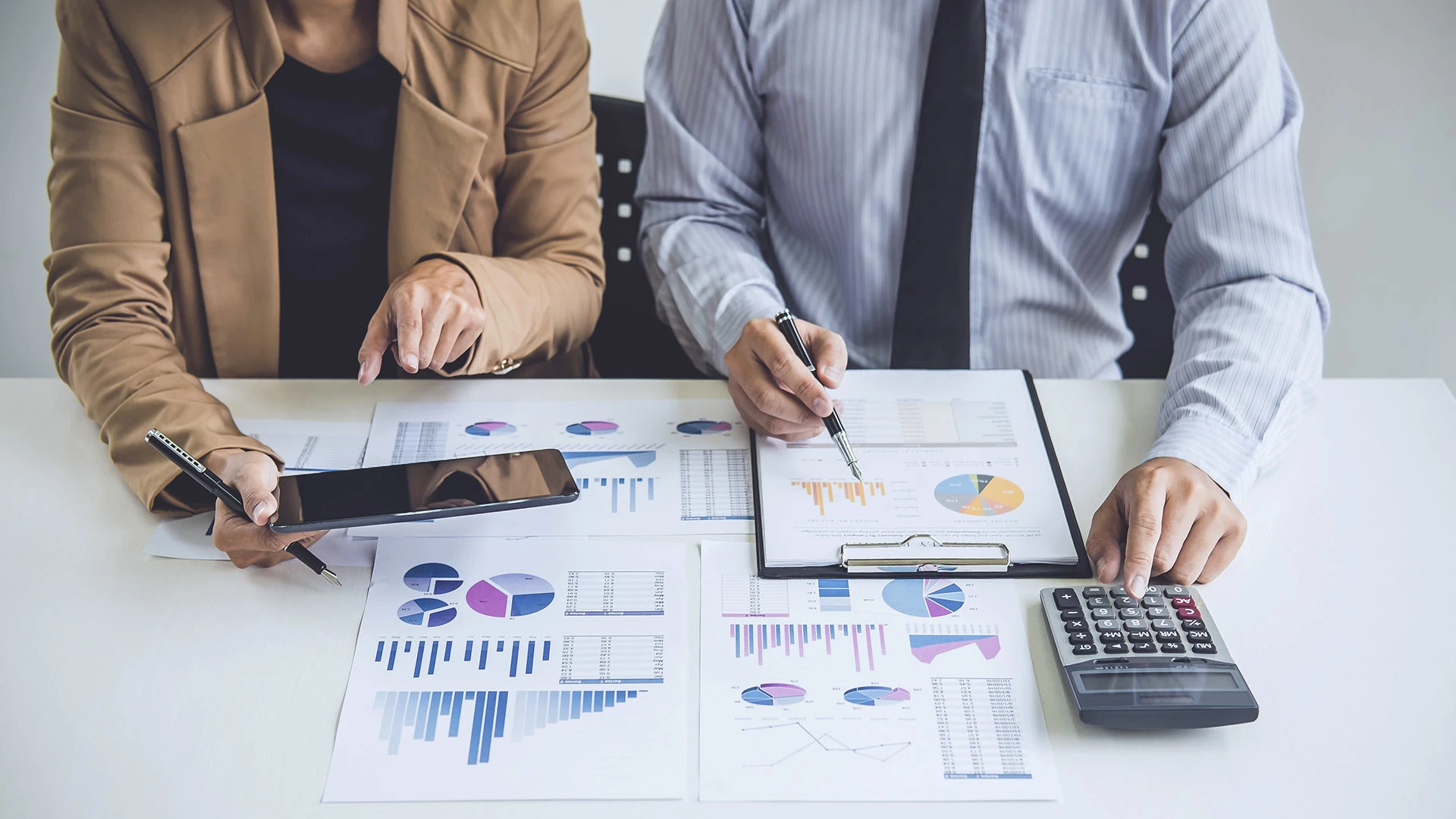 People looking at data in business attire.