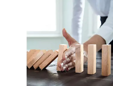 Person blocking wood block from falling.