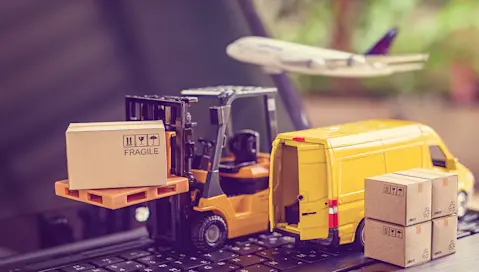 Models of transportation methods in supply chain on laptop keyboard