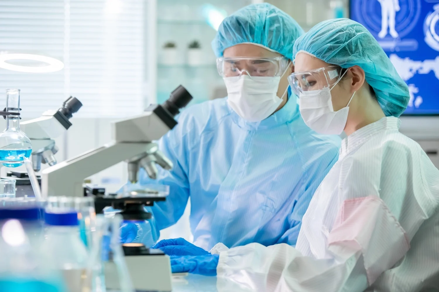 Young scientist using a microscope in a laboratory