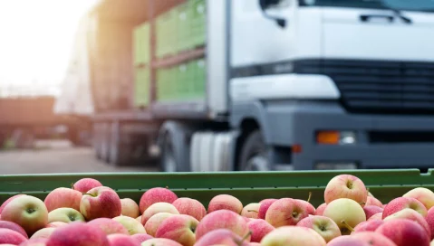 truck behind basket of apples