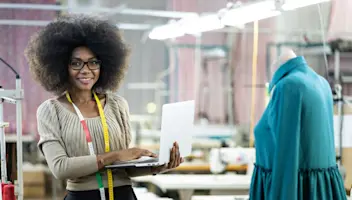 Apparel worker on design floor with laptop