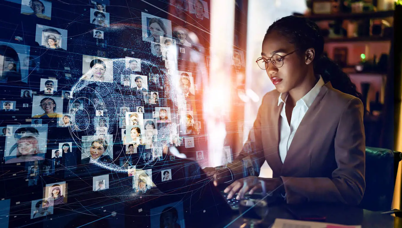 woman on computer looking at photos of people's faces