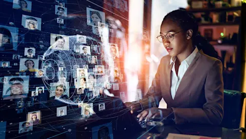 woman on computer looking at photos of people's faces