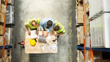 aerial view of warehouse workers on laptop