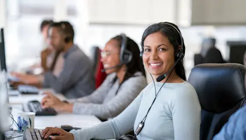 Smiling customer service rep at phone bank