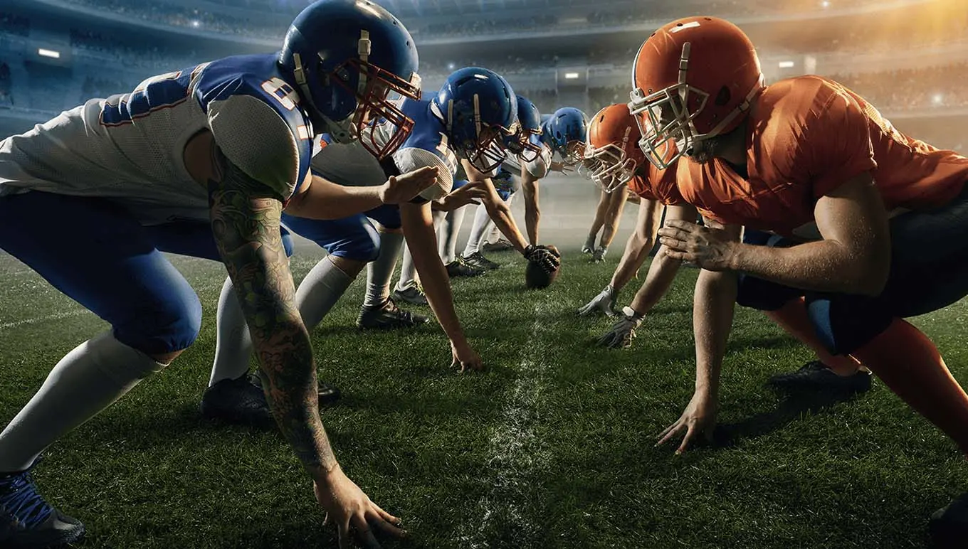 Football players on line of scrimmage