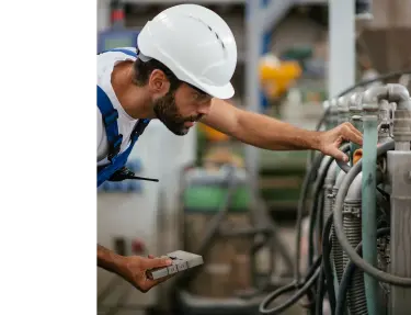 Factory worker inspecting equipment.