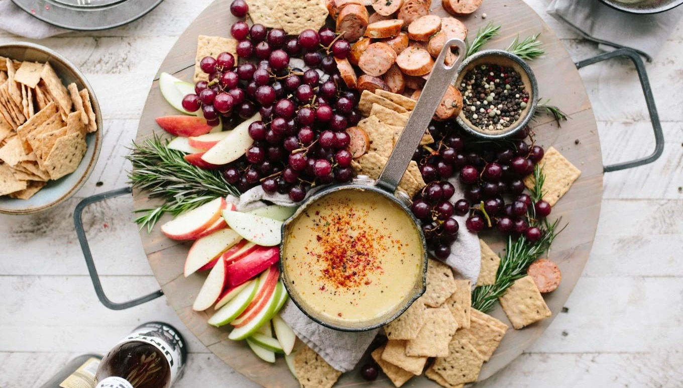 A plentiful charcuterie board filled with delicious foods.