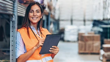 Woman in warehouse on tablet