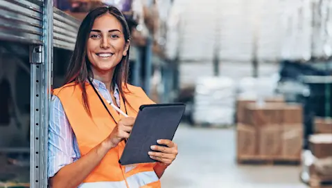 Woman in warehouse on tablet