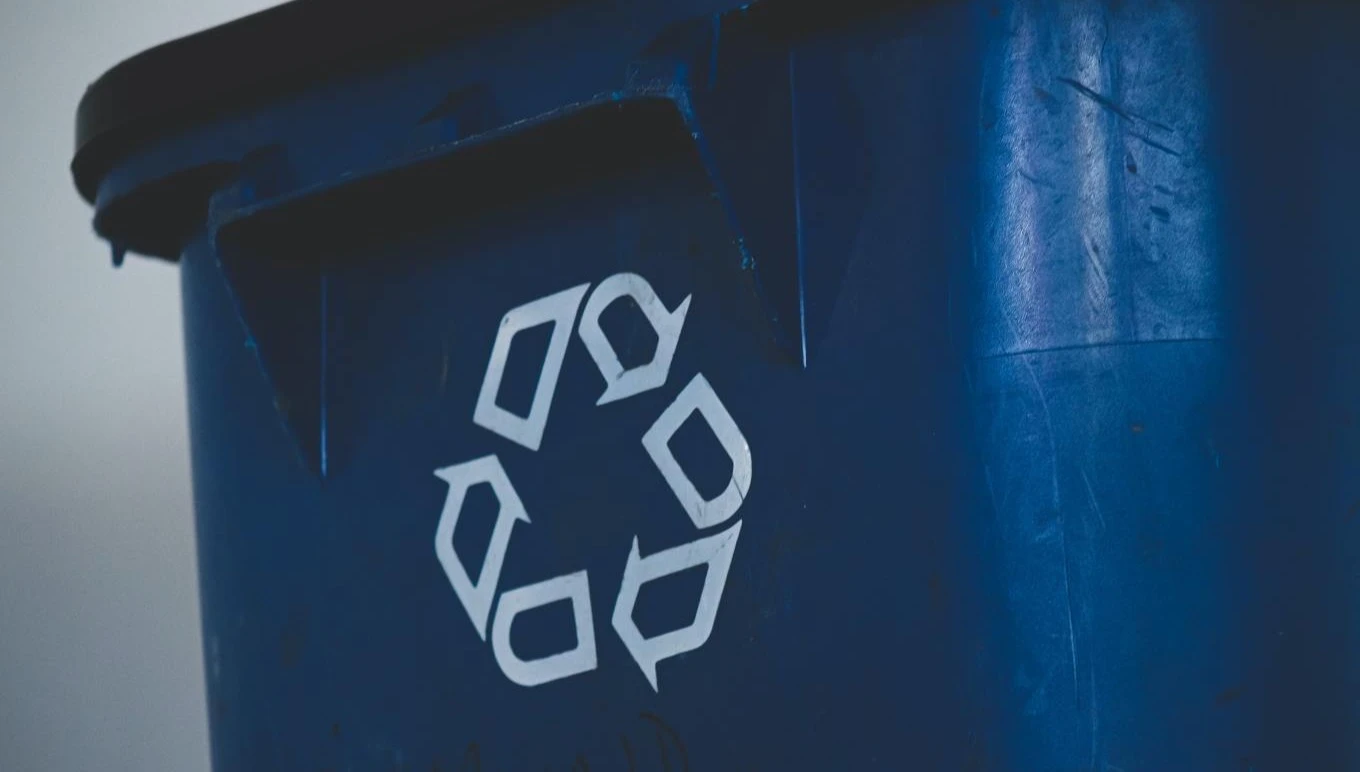 A blue recycling bin.