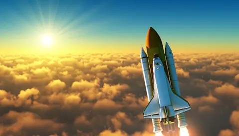 Space shuttle breaking through clouds