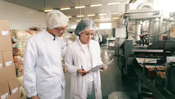 Food facility workers review paperwork.