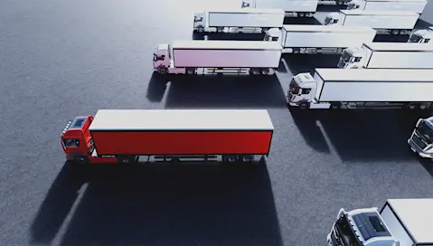 White trucks where the front one is red.