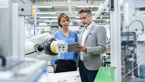Business people checking robot hand