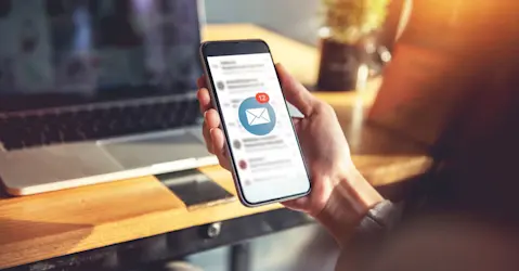 Person holding a smartphone with messages.