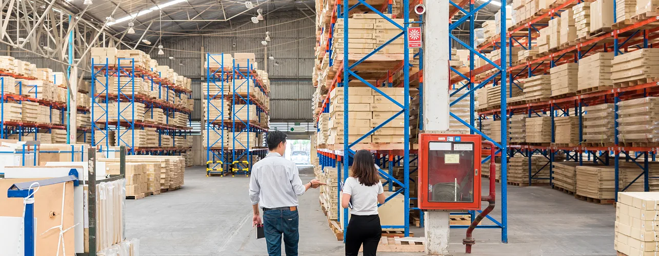 Warehouse officer checking inventory on storage shelves