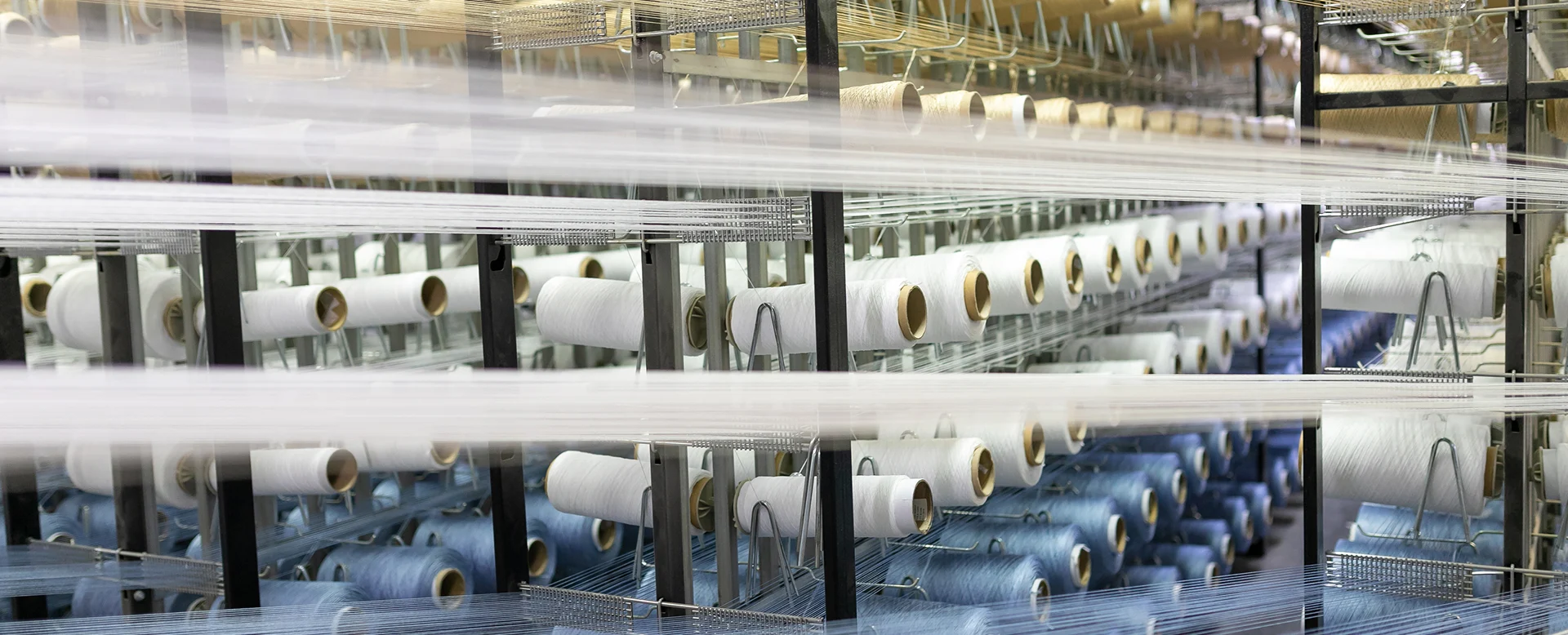 Synthetic yarns being prepared for carpet production in a textile factory