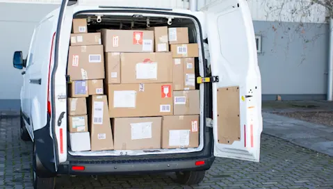 White delivery van full of packages for delivery