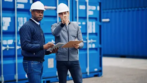 Men in hardhats in warehouse