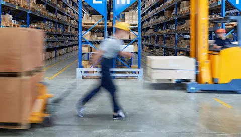 blurred worker in warehouse