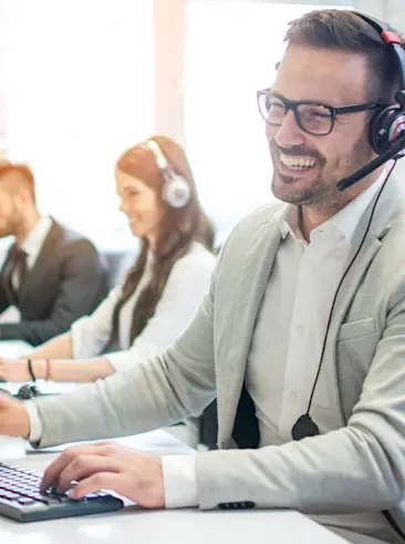 Team working in office with headsets.