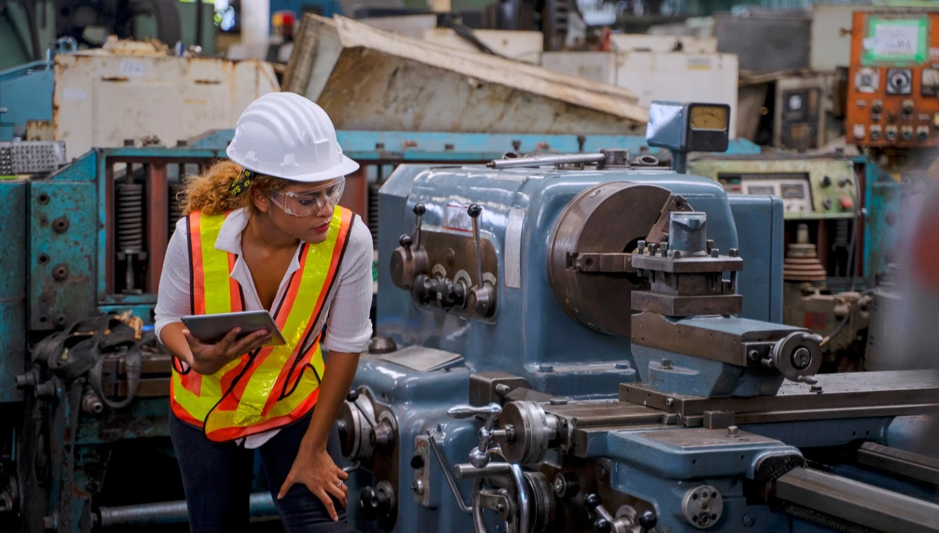 Worker inspecting machinery