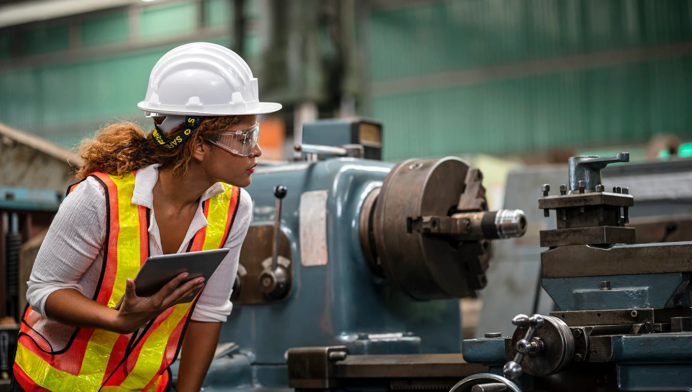 woman in a hardhat on shop floor