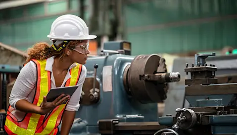woman in a hardhat on shop floor