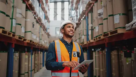 man in factory with tablet