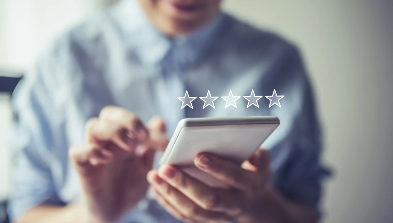 Person using mobile with star rating
