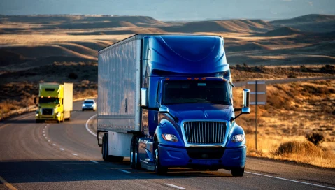 Two long haul trucks on desert highway