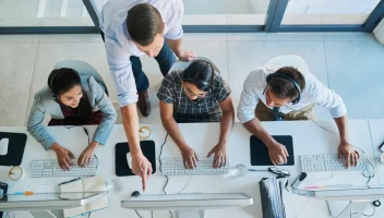 Four Individuals looking at a computer