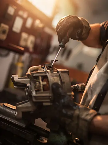 Shop repair worker fixing motor