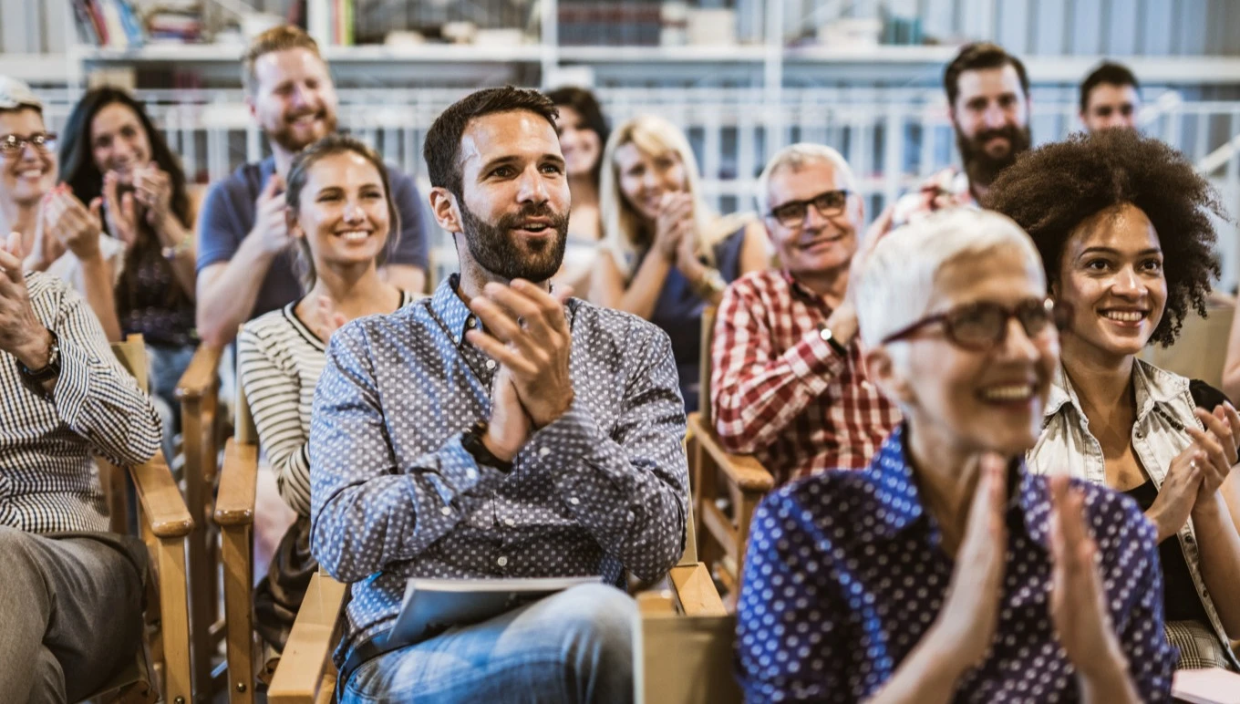A crowd applauds an excellent presentation.