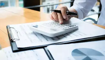 Person using a calculator on a desk