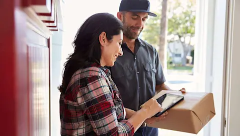 Woman home signing for delivery