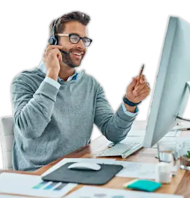 Man sitting at a computer desk using headset microphone.