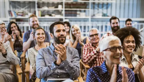 People at business meeting clapping