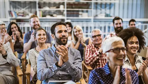 People at business meeting clapping