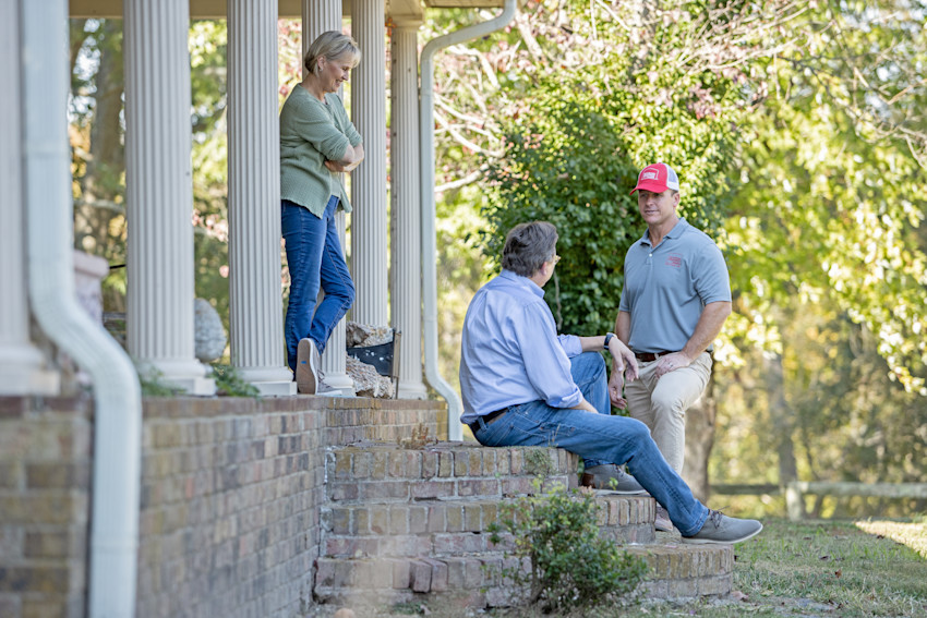 Farm Bureau Insurance of Tennessee agent meeting with two homeowners on their front porch