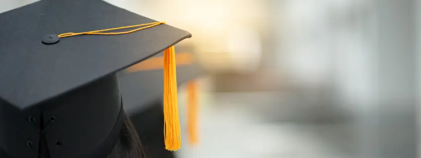 Graduate celebrates commencement ceremony, wearing cap with tassle