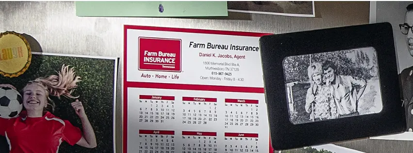 Farm Bureau Insurance of Tennesse calendar surrounded by family photos on bulletin board