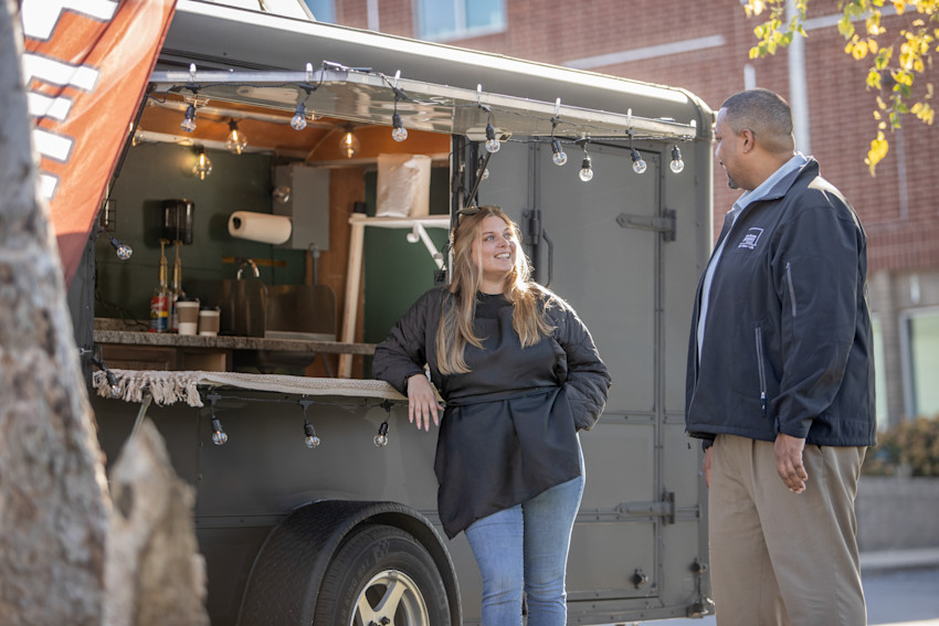 Food truck business owner talking to a Farm Bureau Insurance of Tennessee agent next to her food truck