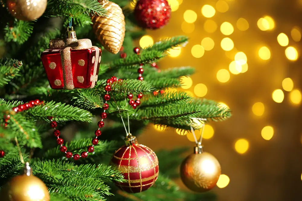 Christmas tree decorated with red and gold ornaments and lights