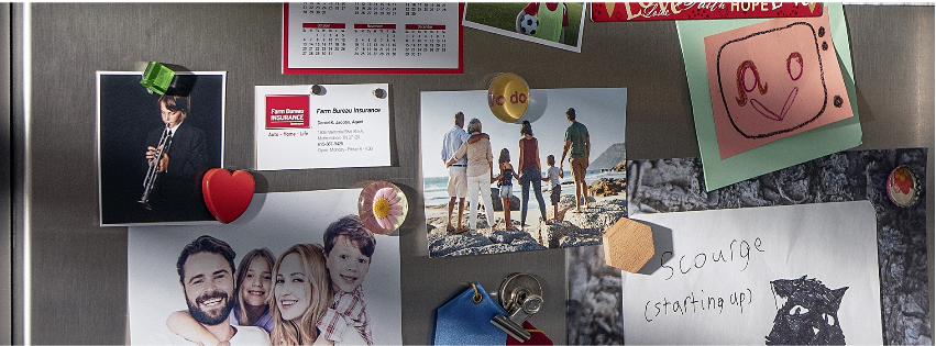 Refrigerator covered with pictures and magnets.